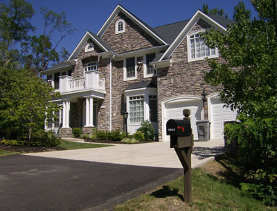 stonework with white trim and garage