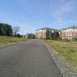 A paved lane and nearby housing