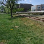 Railroad tracks separate the park from the city