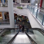 Will Nesbitt waves as he rides the escalator down