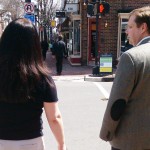 Husband and wife wait to cross the road