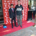 A gentleman gets a photo with one of the film directors
