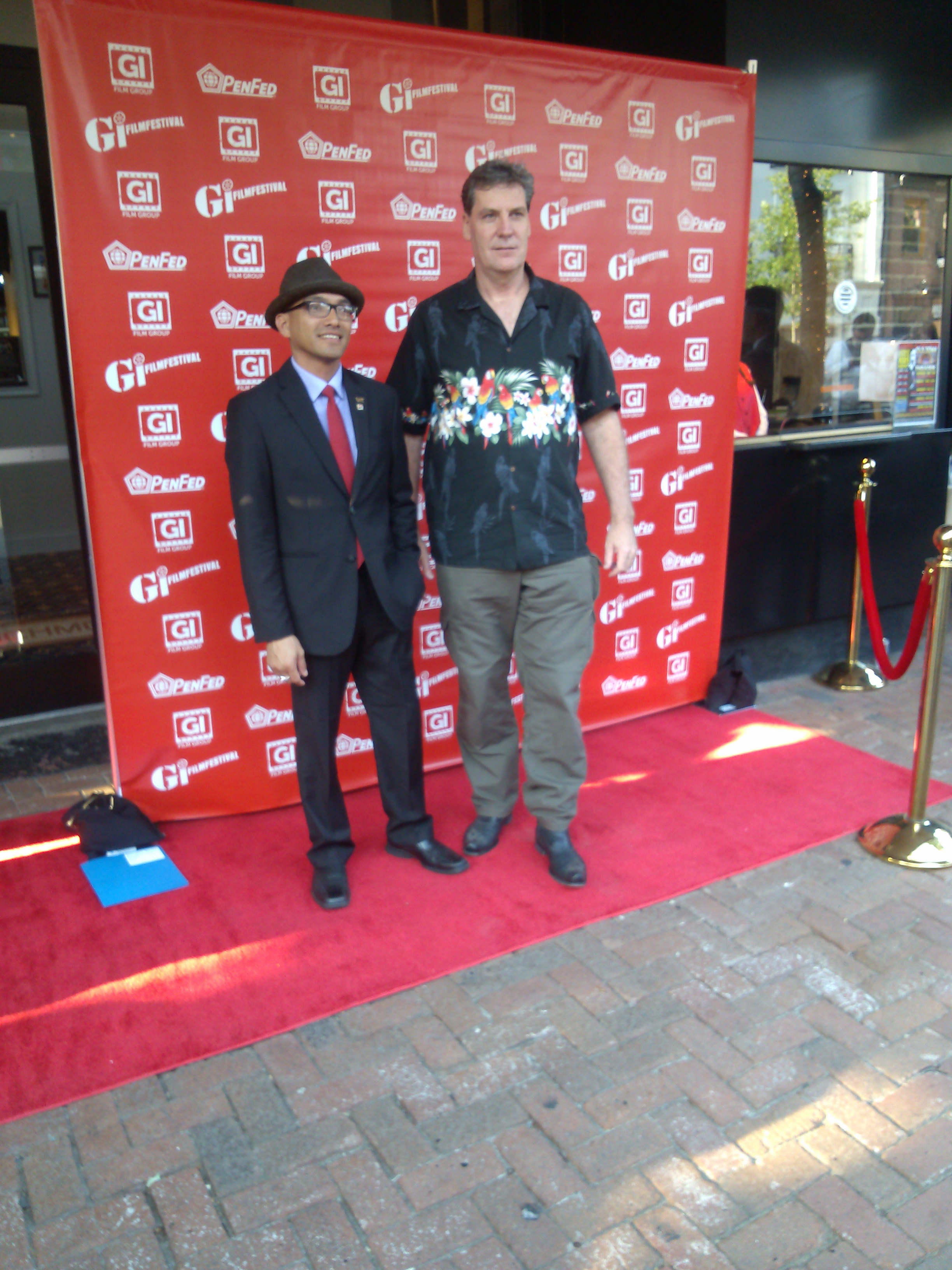 A gentleman gets a photo with one of the film directors