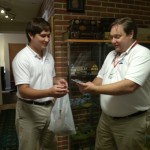 Will Nesbitt looks happily surprised at the miniature handed to him from his younger son Aubrey