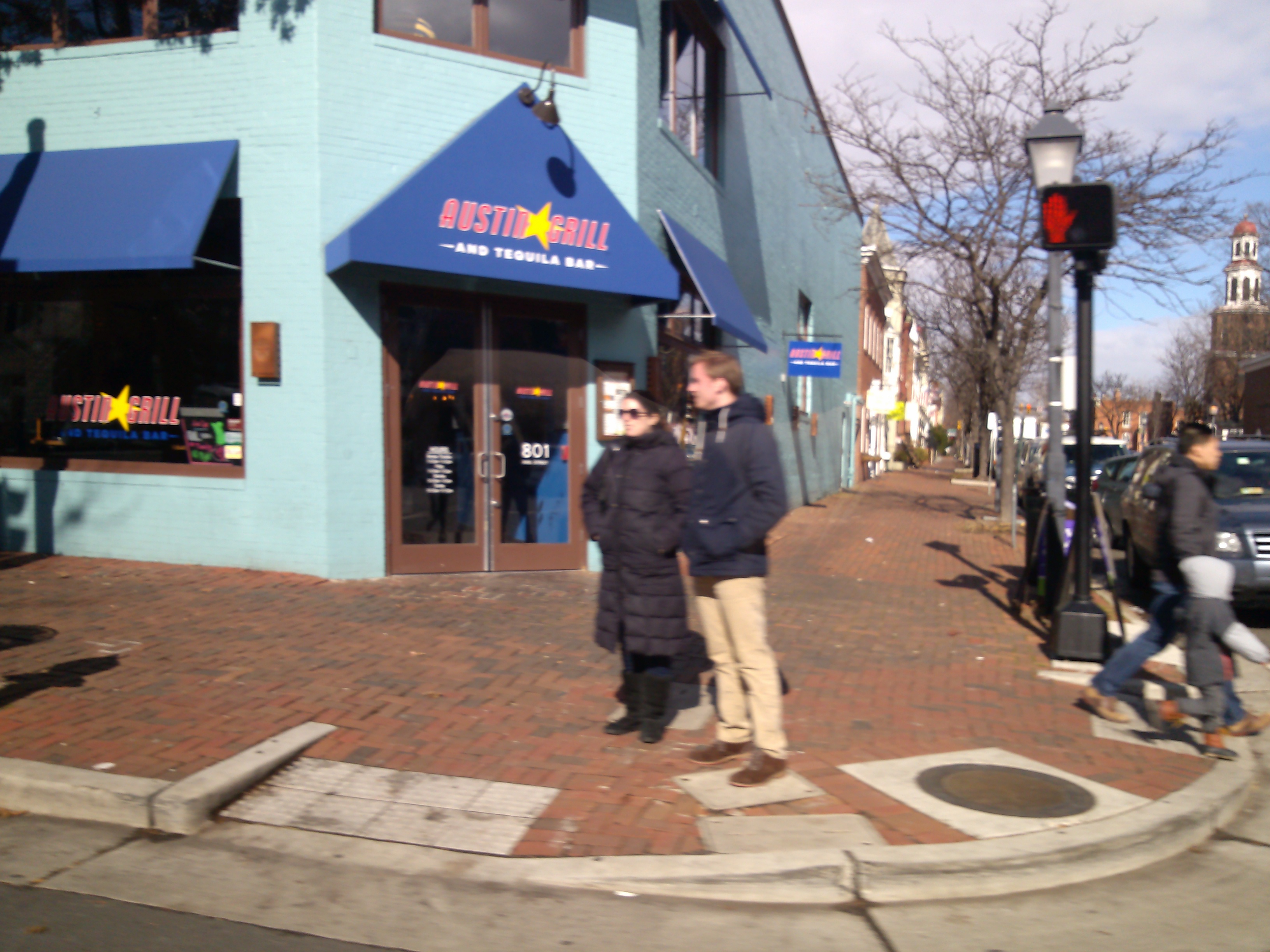 A couple stand outside of Austin Grill in Old Town, Alexandria