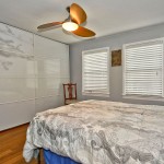 The master bedroom has a stylish fan