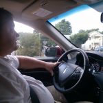 Principal Broker Will Nesbitt driving his sports utility vehicle Lincoln via Arlington