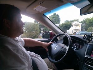 Principal Broker Will Nesbitt driving his sports utility vehicle Lincoln via Arlington