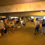 Vendors selling goods in a parking garage basement