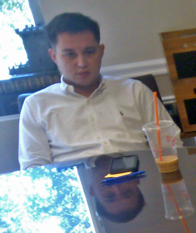 Stuart Nesbitt, Realtor cell phone on table and Baskin Robins / Dunkin Donuts melted ice coffee during meeting